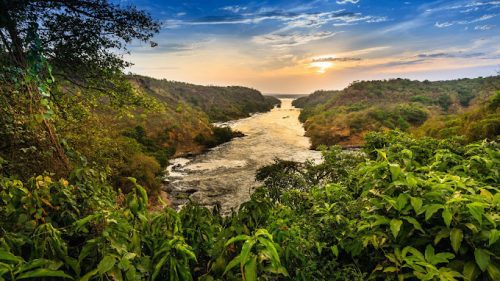 family Uganda safari packages with children enjoying a wildlife boat cruise